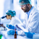 Laboratory professionals using workstations to conduct testing and research, illustrating standard versus custom workstation solutions for operational efficiency.