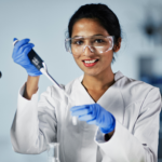 Laboratory technician working at a technical workstation, illustrating the need for custom industrial workbenches to improve workflow and productivity.