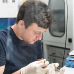 Technician working at a custom semiconductor manufacturing workstation designed for precision, efficiency, and process-specific tasks.