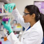 Laboratory technician working at a technical workstation, highlighting how workspace design affects productivity in manufacturing environments.