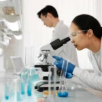 Laboratory professionals working at adaptable lab workstations, illustrating flexible laboratory design that can accommodate changing research needs.