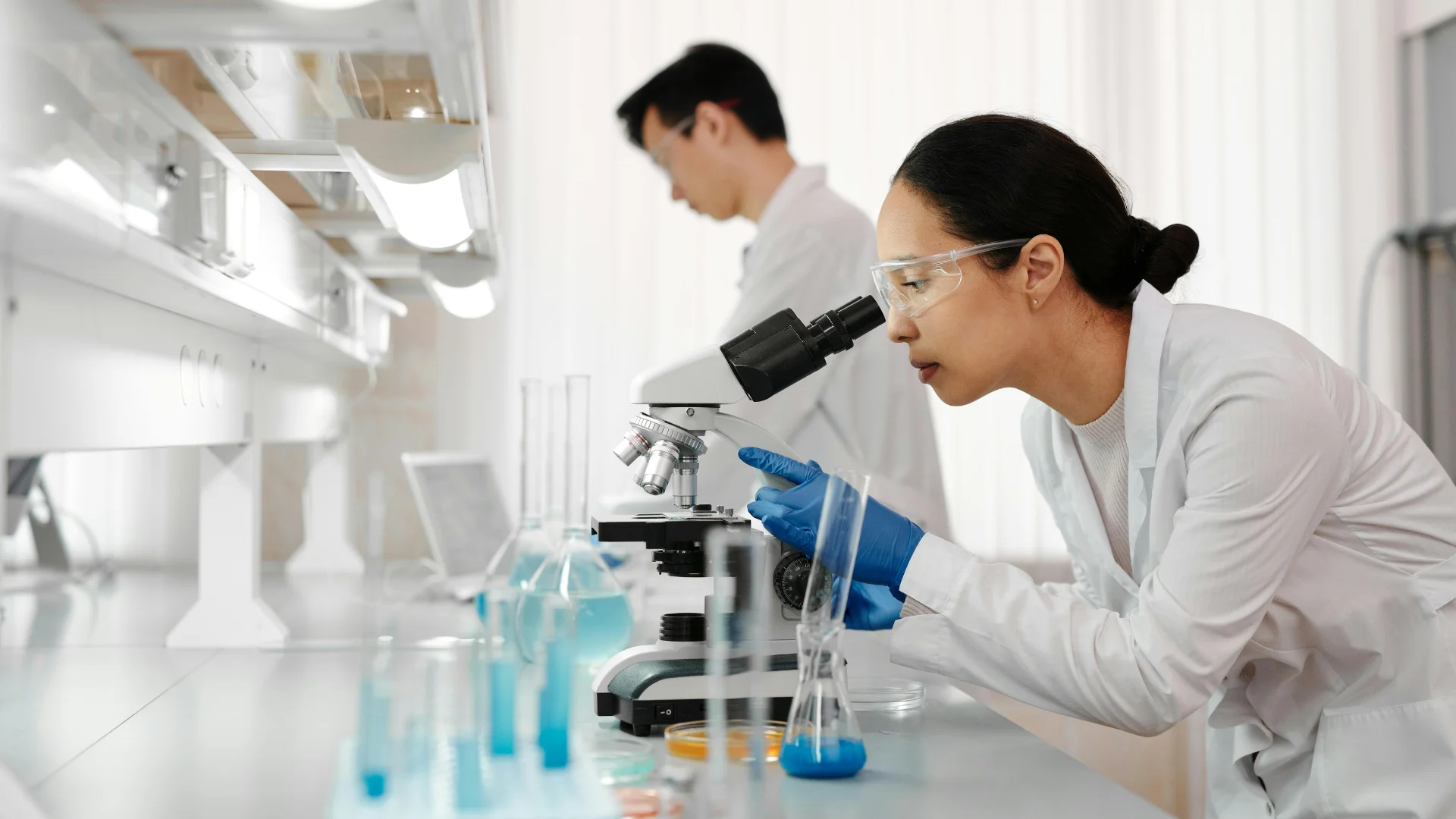 Laboratory professionals working at adaptable lab workstations, illustrating flexible laboratory design that can accommodate changing research needs.